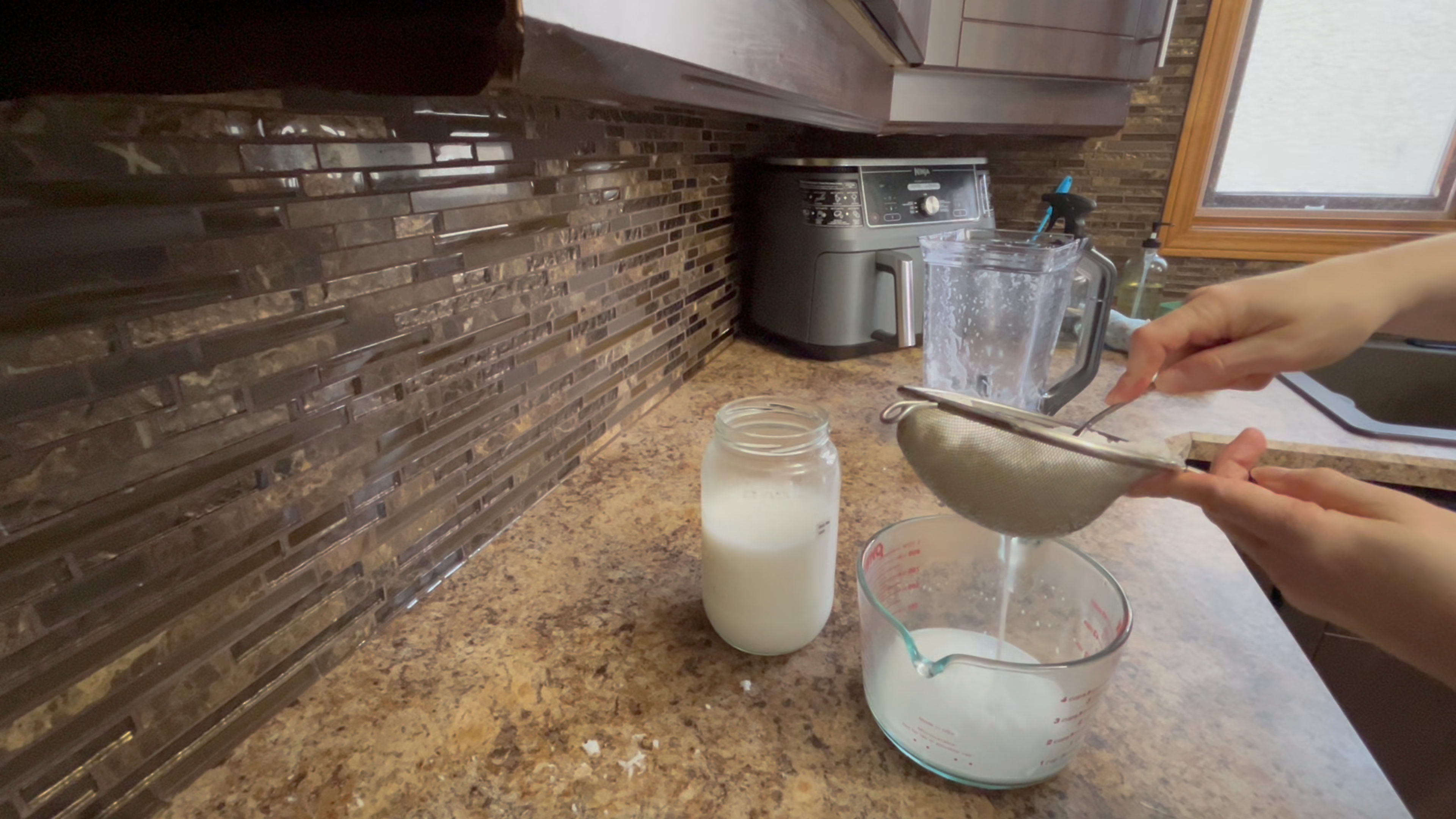 straining coconut milk